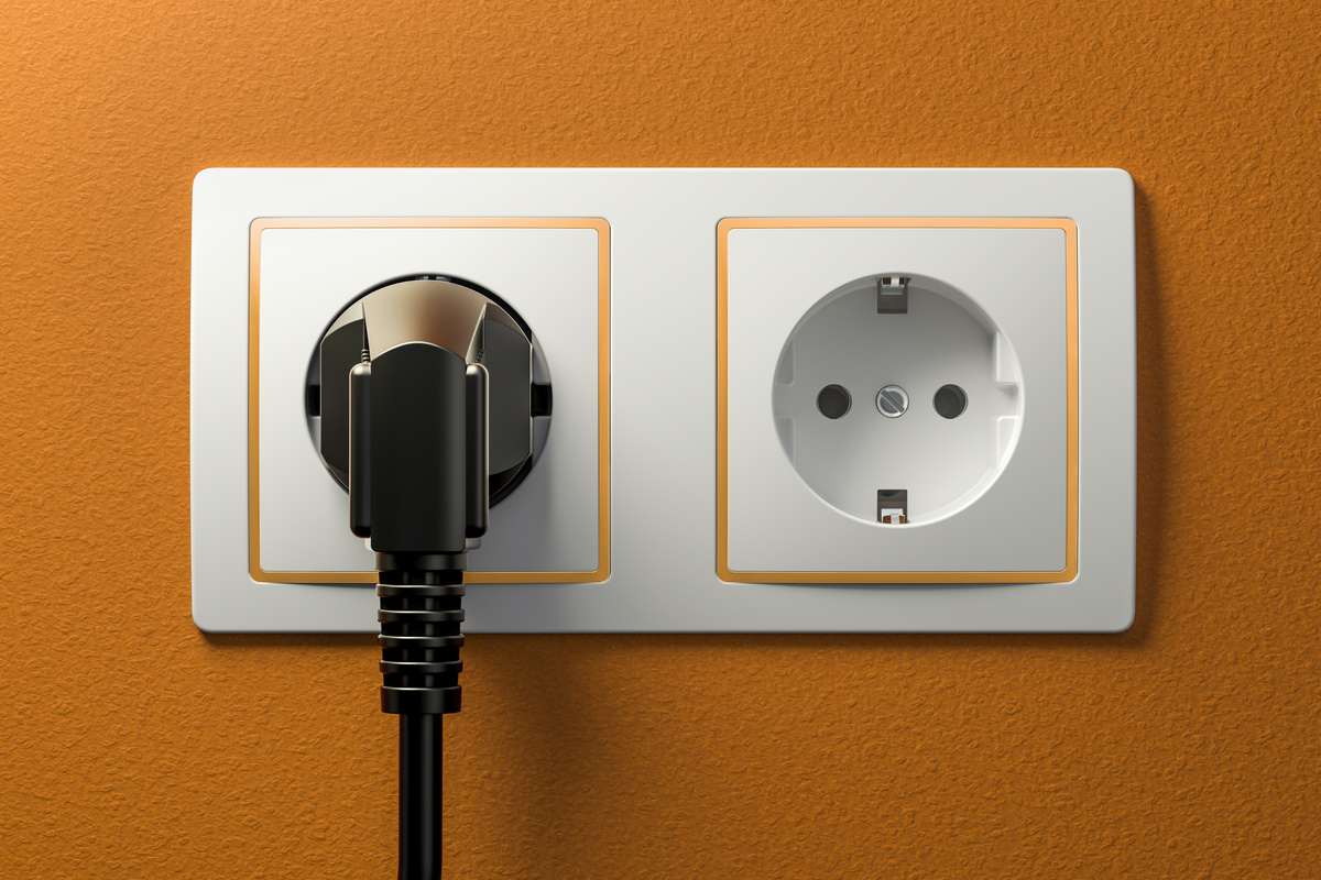 Power Plug into Electrical Socket 3D Rendering